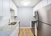 Thumbnail 17 of 21 - a kitchen with stainless steel appliances and white cabinets