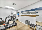 Thumbnail 9 of 41 - the gym with a reformer exercise bike and a wall with a sign that reads