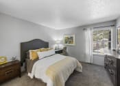 Thumbnail 24 of 37 - a bedroom with a large bed and a large window