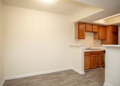 Thumbnail 8 of 21 - an empty dining room off of a kitchen