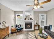 Thumbnail 25 of 41 - an open living room with a fireplace and a ceiling fan