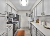 Thumbnail 20 of 41 - a kitchen with white cabinets and stainless steel appliances