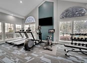 Thumbnail 8 of 29 - A spacious home gym with a variety of exercise equipment.