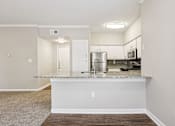 Thumbnail 30 of 54 - A kitchen with a white countertop and a sink.