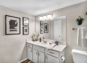 Thumbnail 30 of 41 - a white bathroom with a sink and a mirror