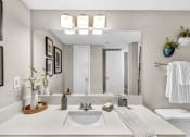 Thumbnail 29 of 41 - a bathroom with a sink and a mirror