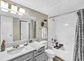 Thumbnail 31 of 41 - a bathroom with a sink and a toilet and a shower