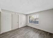 Thumbnail 31 of 37 - a bedroom with hardwood floors and white walls
