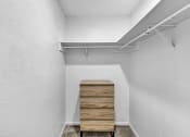 Thumbnail 32 of 41 - room with white walls and a wooden chest of drawers in the corner