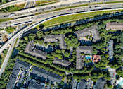 Thumbnail 16 of 80 - A bird's eye view of a residential area with houses and a highway.