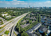 Thumbnail 17 of 80 - A highway interchange with a city skyline in the distance.