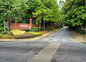 Thumbnail 28 of 80 - A street view of a residential area with a sign that reads "Arborcates.".