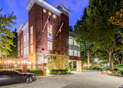 Thumbnail 34 of 80 - A gym building with a car parked in front.