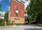 Thumbnail 35 of 80 - A red brick building with the word "GYM" on it.