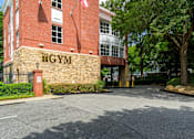 Thumbnail 36 of 80 - A gym is located in a red brick building.