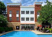 Thumbnail 53 of 80 - A swimming pool in front of a two-story building.