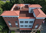 Thumbnail 55 of 80 - A red and white building with a flag on the right side.