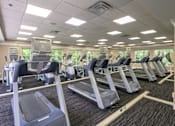 Thumbnail 68 of 80 - A gym with treadmills and elliptical machines.
