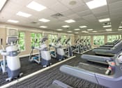 Thumbnail 69 of 80 - A gym with treadmills and elliptical machines.