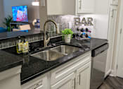 Thumbnail 10 of 80 - A kitchen with a sink and a sign that says "BAR".