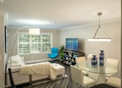 Thumbnail 12 of 80 - A modern living room with a glass table and a blue chair.