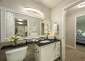 Thumbnail 15 of 80 - A bathroom with a white tub, sink, and mirror.