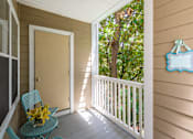 Thumbnail 80 of 80 - A chair with a yellow flower on it is on a porch.