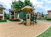 Thumbnail 7 of 14 - A playground with a green slide and a yellow canopy.