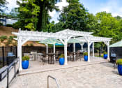 Thumbnail 21 of 30 - Gazebo and grilling area by pool at Collier Ridge Apartments in Atlanta GA