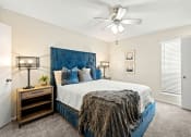 Thumbnail 9 of 20 - a bedroom with a bed and a ceiling fan at Keller Oaks, Carrollton ?