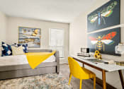 Thumbnail 10 of 20 - a bedroom with a bed and a desk with a computer at Keller Oaks, Carrollton Texas?
