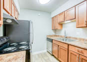 Thumbnail 11 of 32 - a kitchen with wood cabinets and a sink and a refrigerator at The Grove Brentwood, Tennessee, 37211