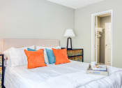 Thumbnail 20 of 32 - a bedroom with a bed with blue and orange pillows at The Grove Brentwood, Nashville Tennessee?