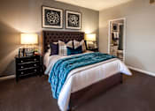 Thumbnail 2 of 14 - A bedroom with a large bed and two lamps.