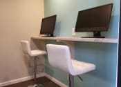 Thumbnail 11 of 32 - a desk with two computer monitors and two chairs