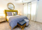 Thumbnail 10 of 30 - a bedroom with a bed and a mirror