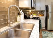 Thumbnail 2 of 30 - a kitchen with stainless steel appliances and a sink