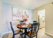 Thumbnail 21 of 32 - a dining room with a wooden table and chairs