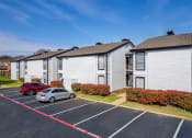 Thumbnail 19 of 20 - a row of houses with cars parked in a parking lot at Keller Oaks, Carrollton, 75006 ?