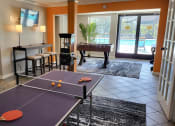 Thumbnail 9 of 32 - a game room with a ping pong table and a pool table