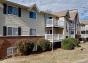 Thumbnail 4 of 32 - the view of an apartment building with a balcony and a brick wall at The Grove Brentwood, Tennessee ?