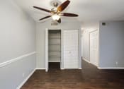 Thumbnail 7 of 32 - an empty living room with a ceiling fan and a closet at The Grove Brentwood, Tennessee, 37211