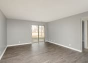 Thumbnail 13 of 32 - an empty living room with wood floors and a sliding glass door at The Grove Brentwood, Tennessee ?