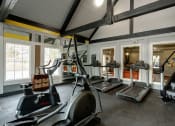 Thumbnail 3 of 32 - a gym with treadmills and other exercise equipment in a building with windows at The Grove Brentwood, Nashville ?
