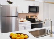 Thumbnail 4 of 20 - a kitchen with stainless steel appliances and a sink with oranges at Keller Oaks, Carrollton, TX ?