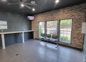Thumbnail 15 of 32 - an empty room with a table and chairs and a brick wall