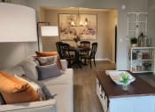 Thumbnail 22 of 32 - a living room with a couch and a table