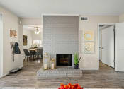 Thumbnail 7 of 20 - a living room with a white brick fireplace and a dining room at Keller Oaks, Texas ?
