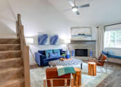 Thumbnail 5 of 30 - a living room with a blue couch and a fireplace