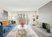 Thumbnail 8 of 20 - a living room with a blue couch and a table and a window at Keller Oaks, Carrollton ?